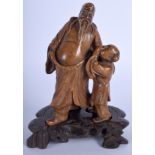 A 19TH CENTURY CHINESE CARVED HARDSTONE FIGURE OF A SCHOLAR modelled beside a laughing boy. 15 cm x
