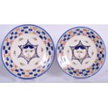 A PAIR OF ISLAMIC POTTERY DISH, decorated with a central portrait, signed. 22 cm wide.