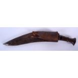 A 19TH CENTURY NEPALESE GURKHA KUKRI, formed with leather scabbard. 48 cm long.