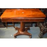 AN EARLY 20TH CENTURY WOODEN CARD TABLE, formed with bun feet. 77 cm x 95 cm.