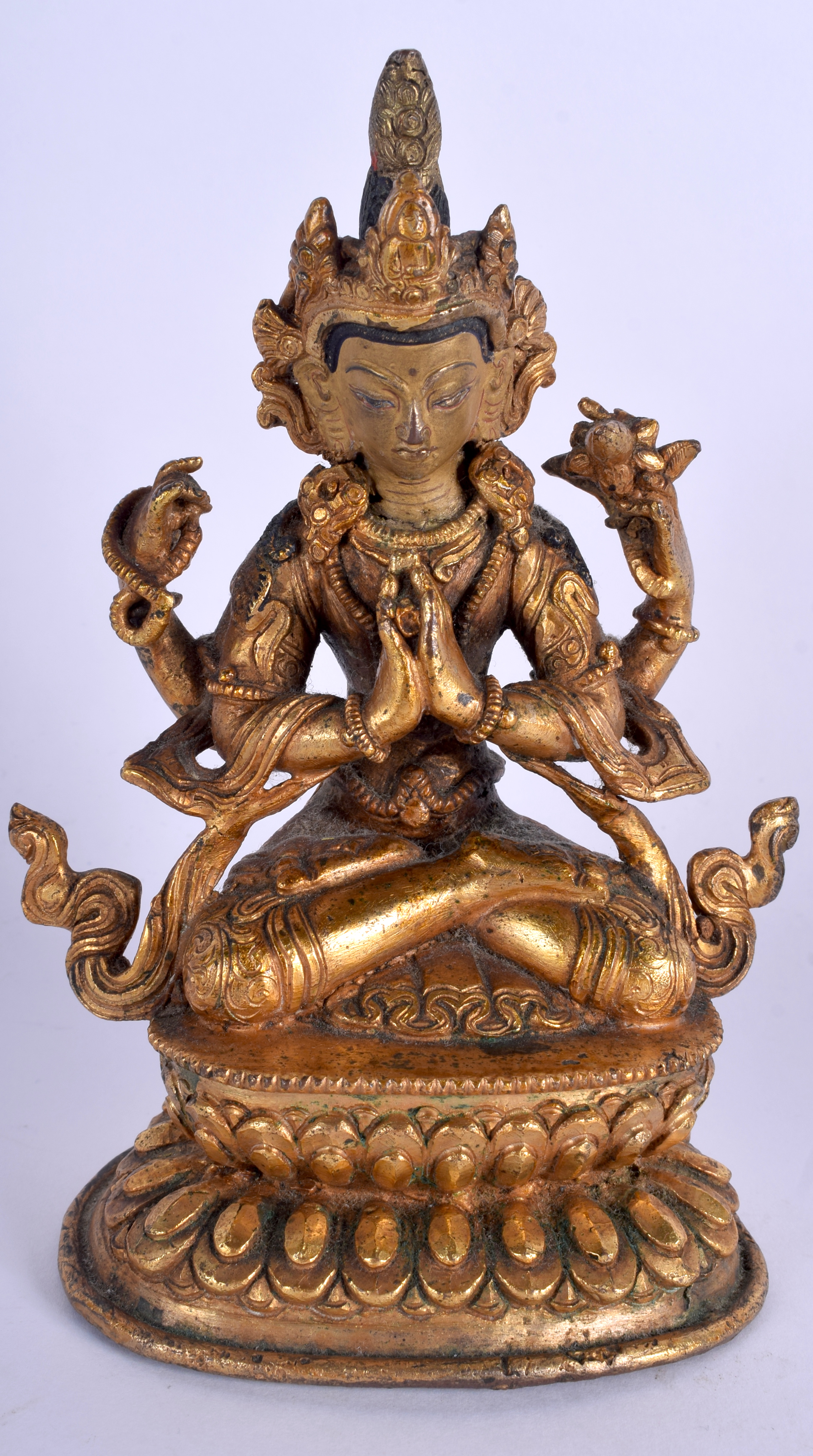 AN EARLY 20TH CENTURY CHINESE TIBETAN GILT BRONZE FIGURE OF A BUDDHA modelled with hands clasped up