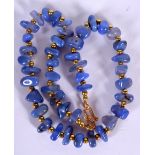 A BLUE AGATE NECKLACE, formed with yellow metal spacers. 46 cm long.