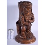 A RARE 19TH CENTURY BAVARIAN BLACK FOREST FIRE LIGHT HOLDER formed as a standing roaming gnome. 44