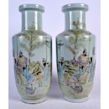 A PAIR OF CHINESE FAMILLE ROSE PORCELAIN ROULEAU SHAPED VASE, painted with scholars in a landscape.