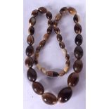 A GOOD EARLY 20TH CENTURY RHINOCEROS HORN BEAD NECKLACE, formed with flattened spherical beads. 70.