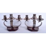 A PAIR OF ARTS AND CRAFTS TYPE SILVER PLATED CANDLESTICKS by Wiskemann. 11 cm x 19 cm.