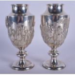 A RARE PAIR OF 19TH CENTURY CHINESE EXPORT SILVER VASES decorated in relief with scholars within la