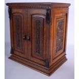 A CHARMING ANTIQUE SMOKING CABINET overlaid with scrolling motifs. 39 cm x 30 cm.