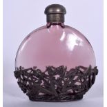AN AMETHYST GLASS WHITE METAL OVERLAID SCENT BOTTLE, the mounts forming dragonflies amongst foliage