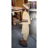 AN UNUSUAL EARLY 20TH CENTURY BUTLERS STAND, in the form of a male in a turban. 92 cm high.