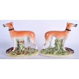 A PAIR OF 19TH CENTURY STAFFORDSHIRE GREYHOUNDS. 18 cm x 18 cm.