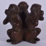 A JAPANESE BRONZE OKIMONO IN THE FORM OF THREE MONKEYS, signed to base. 4 cm high.