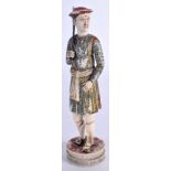 A RARE 19TH CENTURY INDIAN CARVED AND PAINTED IVORY FIGURE OF A MALE modelled holding a sword. 15 c