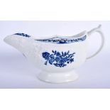 A 18TH CENTURY LOWESTOFT FLORAL MOULDED SAUCEBOAT flower in blue to each side and inside base. 19.5