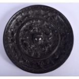 A CHINESE TANG DYNASTY LIONS AND GRAPES BRONZE MIRROR finely cast with a central knob forming a cro