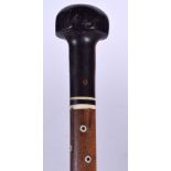 A LIGNUM VITAE WALKING CANE, inlaid with bone. 89 cm long.