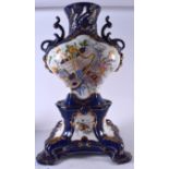 A LARGE FRENCH PORCELAIN VASE ON STAND, decorated with panels of instruments and foliage. 53 cm hig