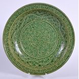 A CHINESE GREEN GLAZED POTTERY DISH, incised with foliage. 28.5 cm wide.