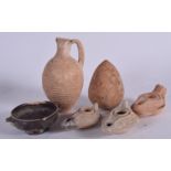 A GROUP OF ISLAMIC POTTERY, three oil lamps together with a jug etc. (6)