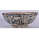 A LARGE PERSIAN POTTERY BOWL, decorated with panels of foliage. 27 cm wide.