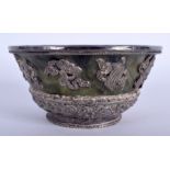 A 19TH CENTURY CHINESE TIBETAN SILVER MOUNTED JADE BOWL decorated with foliage. 9.5 cm wide.