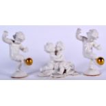 THREE GERMAN PORCELAIN FIGURINES, a pair balancing gilded spheres together with a similar group. Pa