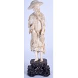 AN EARLY 20TH CENTURY CHINESE CARVED IVORY FISHERMAN modelled holding a pouch. 19 cm high.