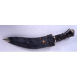 AN EARLY 20TH CENTURY RHINOCEROS HORN HANDLED NEPALESE KUKRI, formed with a “blackened” blade. 37.