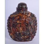 A 19TH CENTURY CHINESE TIBETAN CARVED AMBER SNUFF BOTTLE AND STOPPER Late Qing. 6 cm x 5 cm.