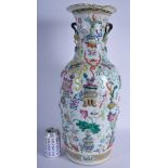 A MID 19TH CENTURY CHINESE FAMILLE ROSE CANTON VASE Qing, decorated with precious objects. 59 cm hi