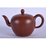 A CHINESE YIXING POTTERY TEAPOT AND COVER of plain form. 14 cm wide.