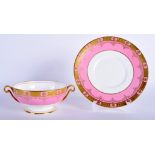 A MINTON TWO HANDLED SOUP BOWL AND STAND with rose pompadour ground and raised gilding, gold mark.
