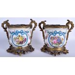 A PAIR OF 19TH CENTURY FRENCH PARIS PORCELAIN CACHE POTS painted with flowers. 17 cm wide.