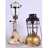 AN ANTIQUE TILLEY LAMP, together with another similar. Largest 47 cm. (2)