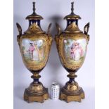 A LARGE PAIR OF 19TH CENTURY FRENCH SEVRES PORCELAIN VASES AND COVERS converted to lamps, painted w