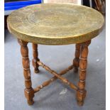 AN EARLY 20TH CENTURY PERSIAN BRASS TRAY TOP TABLE, formed with an English oak stand.