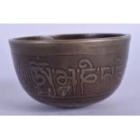 A 19TH CENTURY CHINESE TIBETAN BRONZE BOWL decorated with calligraphy. 6.75 cm wide.