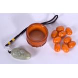 A GROUP OF AMBER BEADS, together with a jade pendant and a napkin ring. (qty)