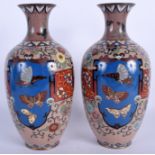 A PAIR OF EARLY 20TH CENTURY JAPANESE MEIJI PERIOD CLOISONNE ENAMEL VASES decorated with foliage. 2
