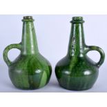 A PAIR OF ARTS AND CRAFTS GREEN GLAZED POTTERY JUGS. 21 cm high.