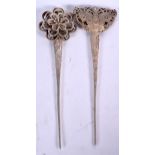 TWO CHINESE WHITE METAL HAIR PINS, one decorated with a butterfly terminal. 19 cm long. (2)