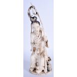 A 19TH CENTURY CHINESE CARVED IVORY FISHERMAN modelled holding a curving pole. 23.5 cm high.