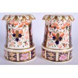 A PAIR OF 19TH CENTURY DERBY IMARI POTTERY VASES painted with flowers. 15 cm high.