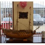 A GOOD SCRATCH BUILT MODEL OF A GALLEON, formed upon a fitted plinth. 99 cm x 120 cm.