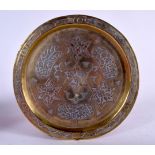 AN EARLY 20TH CENTURY PERSIAN ISLAMIC SILVER INLAID BRASS DISH, decorated with symbols and script e
