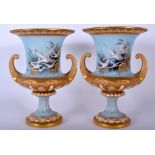 A PAIR OF ROYAL WORCESTER TWIN HANDLED PORCELAIN URN VASES by Charles Baldwyn, painted with swans.