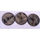 THREE CHINESE MINIATURE BRONZE HAND MIRRORS, varying decoration. 5 cm wide. (3)