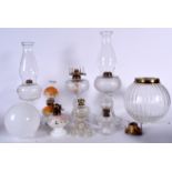 A GROUP OF OIL LAMPS, together with assorted shades. (qty)
