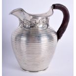 AN ANTIQUE RIBBED SILVER JUG. London 1907. 12.7 oz. 15 cm high.