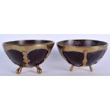 A PAIR OF 18TH/19TH CENTURY COCONUT MOUNTED BOWLS with brass mounts. 8.5 cm wide.